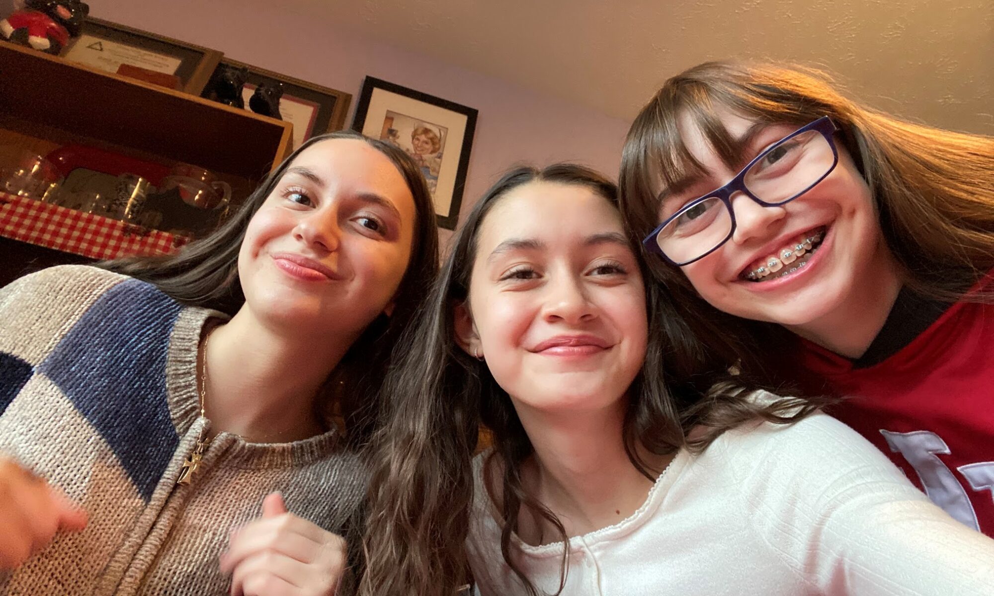 Danielle Heimlich smiles down at the camera with two of her friends
